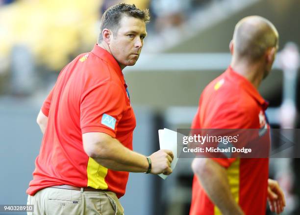 Cats head coach Stuart Dew walks off during the round two AFL match between the Carlton Blues and the Gold Coast Suns at Etihad Stadium on March 31,...