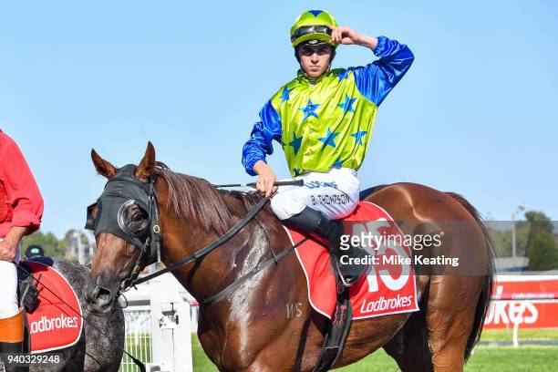 Ben E Thompson returns to the mounting yard on No Commitment after winning the Robert Taranto Handicap, at Caulfield Racecourse on March 31, 2018 in...