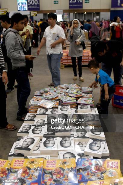 This picture taken on March 30, 2018 shows people browsing through books at the Big Bad Wolf book sale in Serpong in the suburbs of Jakarta. / AFP...