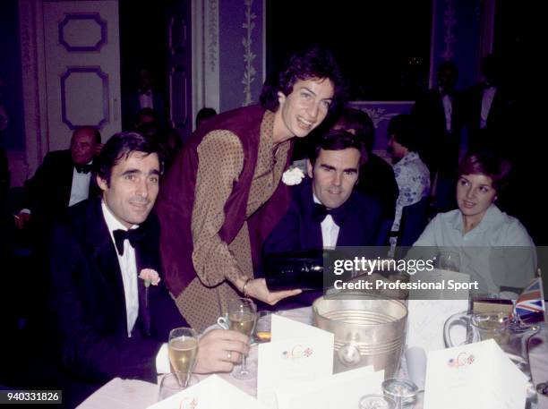 British tennis player Virginia Wade serving champagne to Paul Hutchins and Roger Taylor at an event during the Wightman Cup tennis competition at...