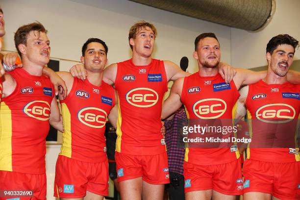 Tom Lynch and Steven May of the Suns sing the club song after winning during the round two AFL match between the Carlton Blues and the Gold Coast...