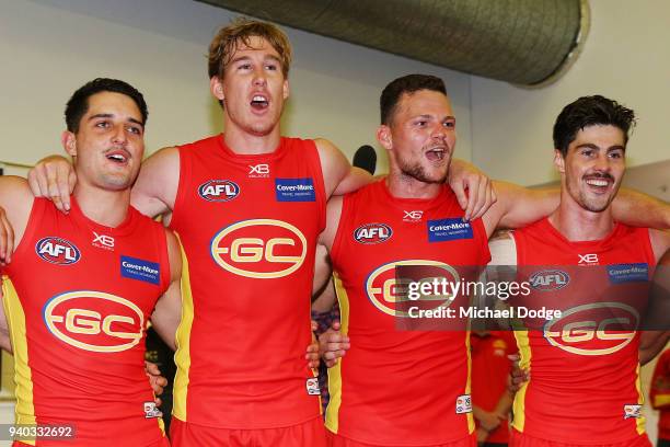 Tom Lynch and Steven May of the Suns sing the club song after winning during the round two AFL match between the Carlton Blues and the Gold Coast...
