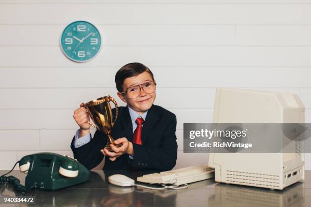 young retro business boy in office with trophy - gold trophy stock pictures, royalty-free photos & images