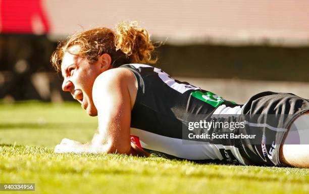 Tim Broomhead of the Magpies lies on the field with a broken leg during the round two AFL match between the Collingwood Magpies and the Greater...