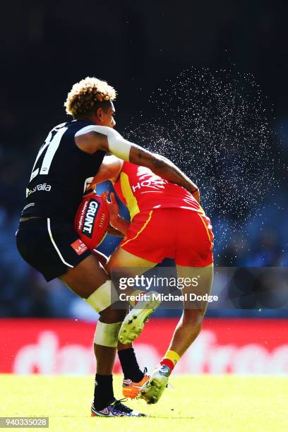 Jarrod Garlett of the Blues tackles Jarrod Harbrow of the Suns during the round two AFL match between the Carlton Blues and the Gold Coast Suns at...