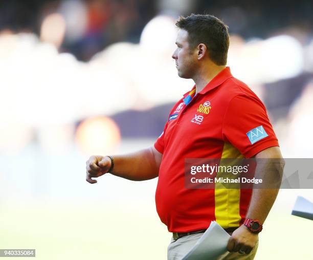 Suns head coach Stuart Dew walks off during the round two AFL match between the Carlton Blues and the Gold Coast Suns at Etihad Stadium on March 31,...