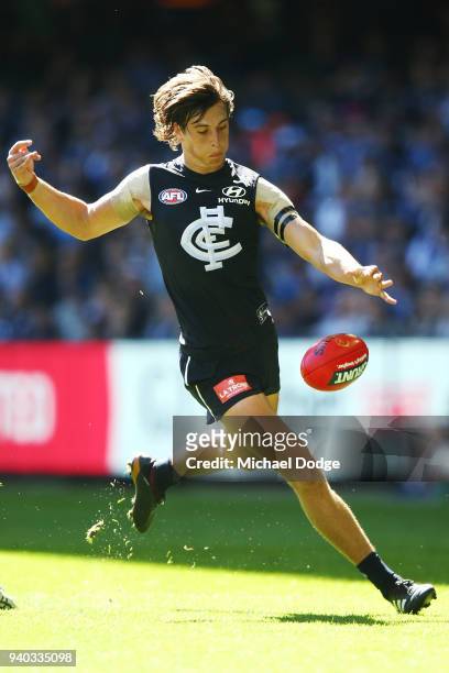 Caleb Marchbank of the Blues kicks the ball during the round two AFL match between the Carlton Blues and the Gold Coast Suns at Etihad Stadium on...