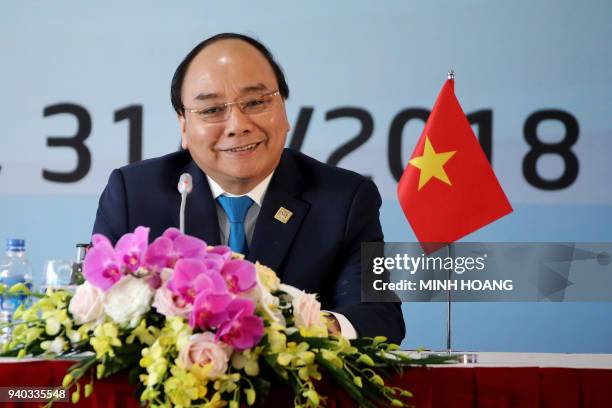 Vietnam's Prime Minister Nguyen Xuan Phuc smiles during a press conference after the Greater Mekong Subregion Summit in Hanoi on March 31, 2018. /...