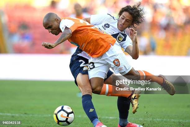 Henrique of the Roar is tackled by Lachlan Wales of the Mariners during the round 25 A-League match between the Brisbane Roar and the Central Coast...