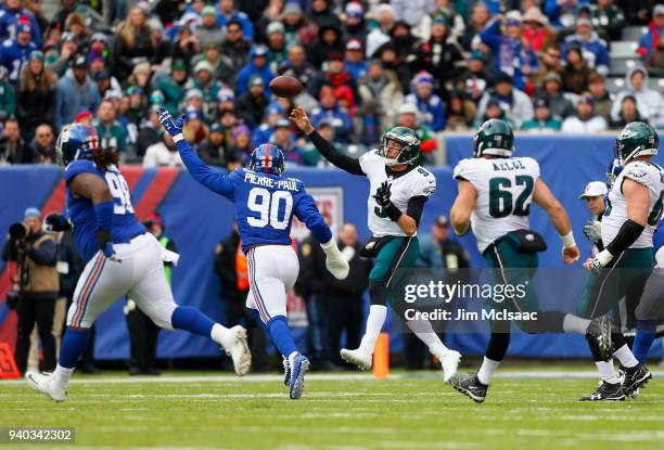 Nick Foles of the Philadelphia Eagles in action against Jason Pierre-Paul of the New York Giants on December 17, 2017 at MetLife Stadium in East...