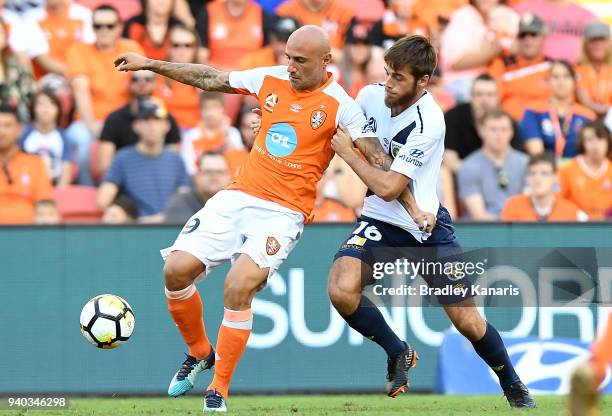 Massimo Maccarone of the Roar is challenged by Liam Rose of the Mariners during the round 25 A-League match between the Brisbane Roar and the Central...