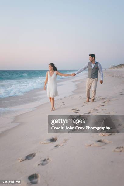 couple on beach - footprints on beach australia stock-fotos und bilder