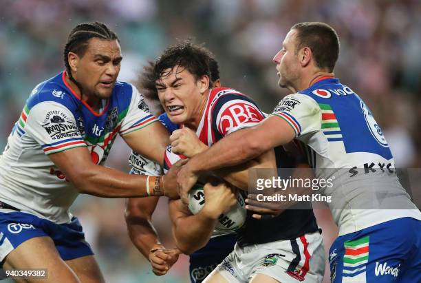 Joseph Manu of the Roosters is tackled during the round four NRL match between the Sydney Roosters and the New Zealand Warriors at Allianz Stadium on...