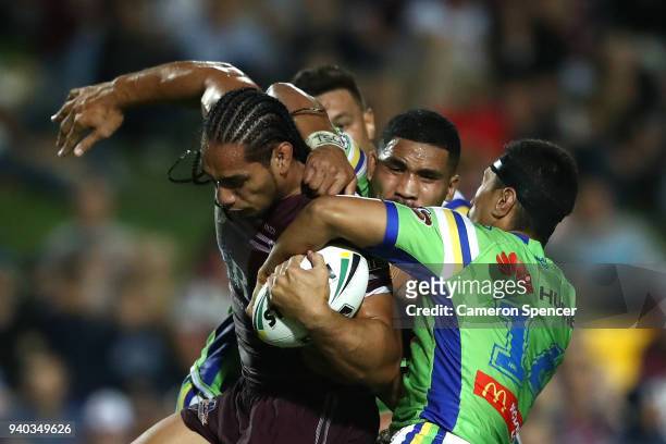 Martin Taupau of the Sea Eagles is tackled during the round four NRL match between the Many Sea Eagles and the Canberra Raiders at Lottoland on March...