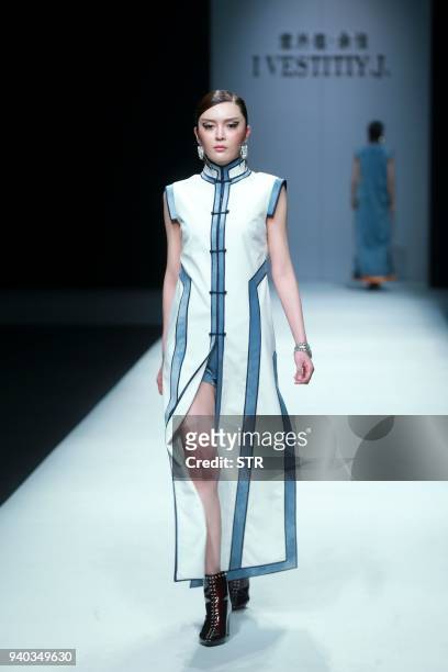 Model parades a creation from the "I VESTITI Y.J." collection by designer Yu Jia during China Fashion Week in Beijing on March 31, 2018. / AFP PHOTO...