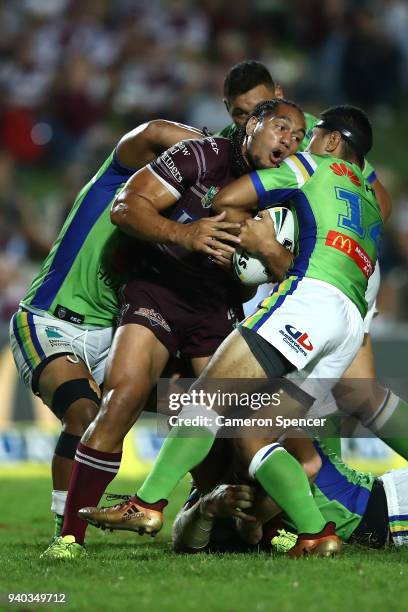 Martin Taupau of the Sea Eagles is tackled during the round four NRL match between the Many Sea Eagles and the Canberra Raiders at Lottoland on March...