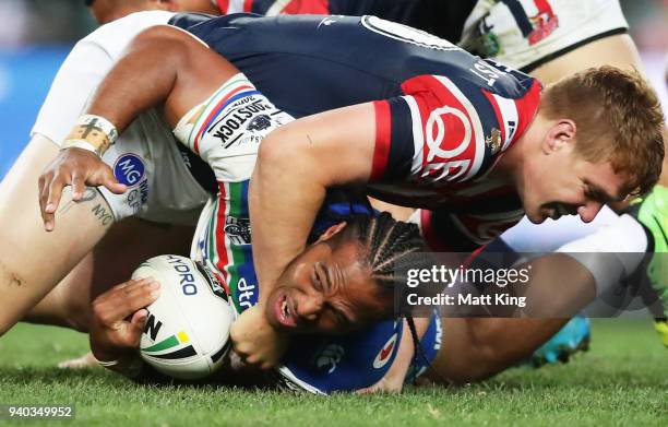 Agnatius Paasi of the Warriors is tackled by Dylan Napa of the Roosters during the round four NRL match between the Sydney Roosters and the New...