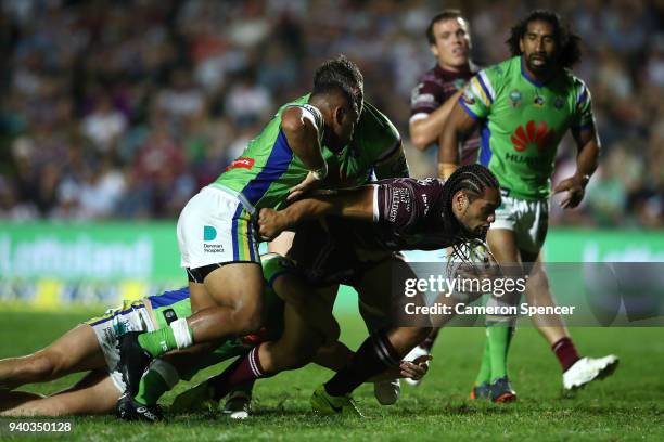 Martin Taupau of the Sea Eagles is tackled during the round four NRL match between the Many Sea Eagles and the Canberra Raiders at Lottoland on March...