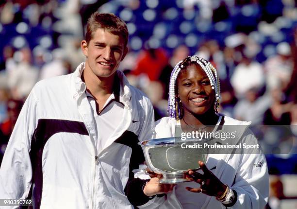 Serena Williams of the USA and Max Mirnyi of Belarus pose with the trophy after defeating Lisa Raymond and Patrick Galbraith both of the USA in the...