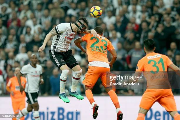 Alvaro Negredo of Besiktas in action against Welinton Souza of Aytemiz Alanyaspor during a Turkish Super Lig week 27 soccer match between Besiktas...