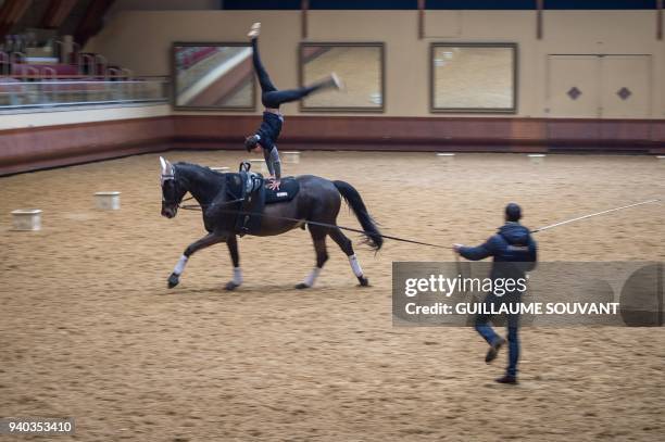 French aerobatic world champion Lambert Le Clezio performs with a horse during a training day at the "Cadre Noir de Saumur" national equestrian...