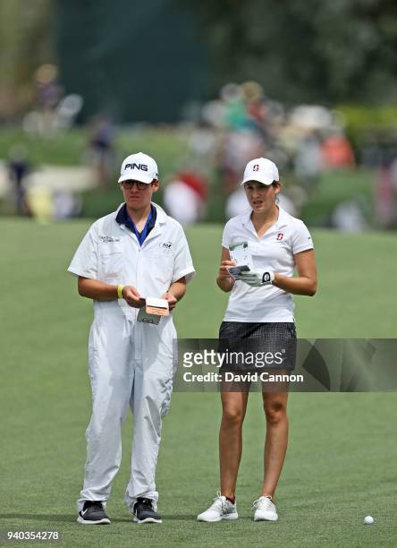 Albane Valenzuela of Switzerland waits to play her second shot on the par 4, first hole with her caddie Alexis Valenzuela during the third round of...