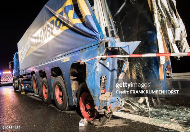 Heavily damaged rear of a truck loaded with panes of glass is pictured after a crash with a bus on the Autobahn 3 motorway on March 31 in...