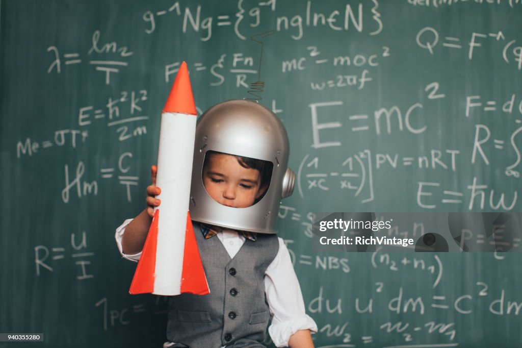 Young Business Boy with Space Helmet and Rocket