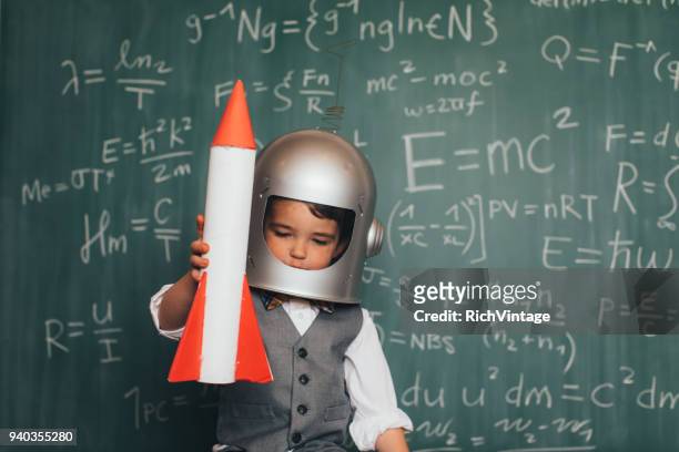 young business boy with space helmet and rocket - astronaut space suit stock pictures, royalty-free photos & images
