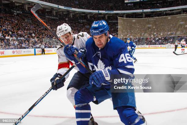 Roman Polak of the Toronto Maple Leafs battles for the puck against Nick Bjugstad of the Florida Panthers during the third period at the Air Canada...