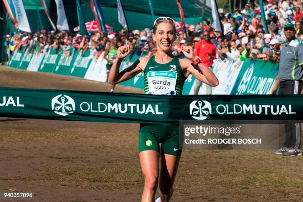 South Africa's Gerda Steyn raises her arms as she crosses the finish line, winning the women's section of the Two Oceans ultra-marathon, on March 31...