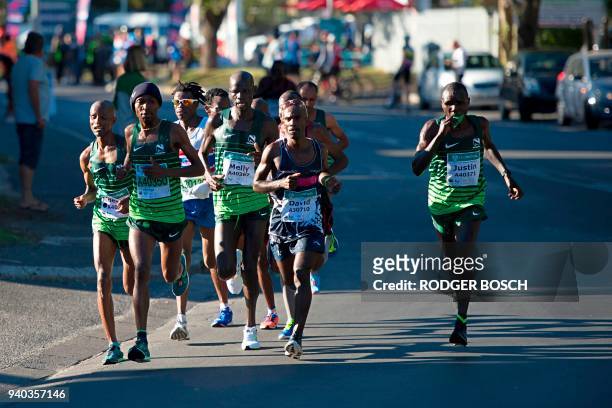 Group of the leading runners run in Hout Bay as they compete in the Two Oceans ultra-marathon, on March 31 in Cape Town. This is the 49th edition of...