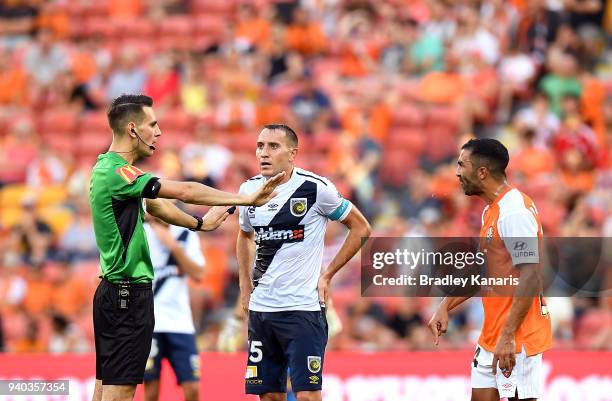 Referee Jonathan Barreiro is challenged on a call by Fahid Ben Khalfallah of the Roar during the round 25 A-League match between the Brisbane Roar...