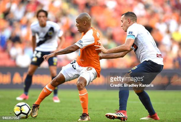 Henrique of the Roar is challenged by the defence during the round 25 A-League match between the Brisbane Roar and the Central Coast Mariners at...