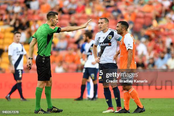 Referee Jonathan Barreiro is challenged on a call by Fahid Ben Khalfallah of the Roar during the round 25 A-League match between the Brisbane Roar...