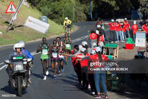 Group of the leading runners get water and other drinks in Hout Bay as they compete in the Two Oceans ultra-marathon, the Two Oceans ultra-marathon,...