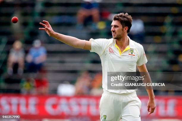 Australian bowler Pat Cummins reaches for the ball on the second day of the fourth Test cricket match between South Africa and Australia won by South...