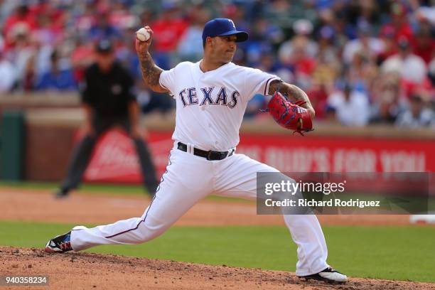 Matt Bush of the Texas Rangers pitches in the eighth inning against the Houston Astros on Opening Day at Globe Life Park in Arlington on March 29,...
