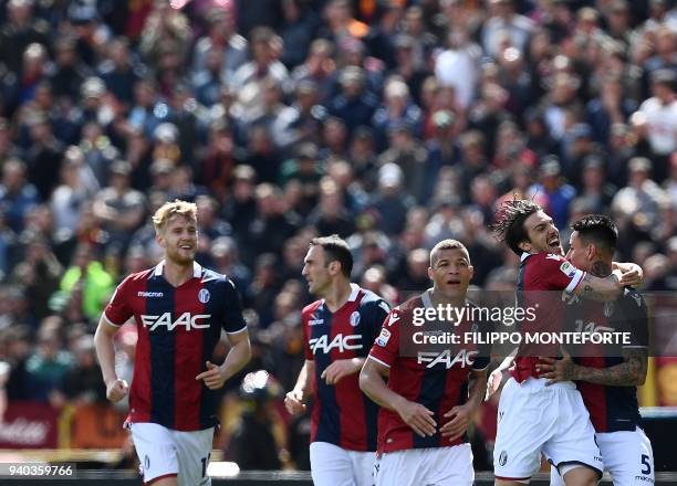 Bologna midfielder from Chile Erick Pulgar celebrates with teammates after scoring during the Italian Serie A football match Bologna vs AS Roma at...