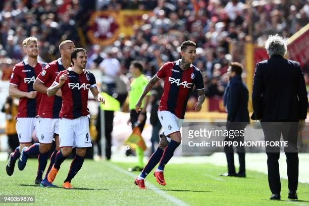 Bologna midfielder from Chile Erick Pulgar celebrates with teammates after scoring during the Italian Serie A football match Bologna vs AS Roma at...