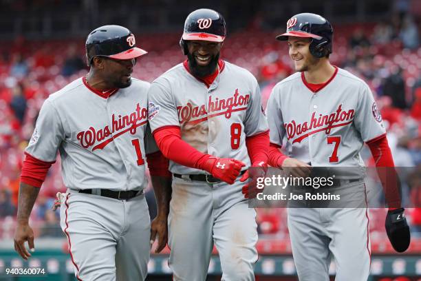 Brian Goodwin of the Washington Nationals celebrates with Howie Kendrick and Trea Turner after hitting a grand slam home run in the ninth inning of...