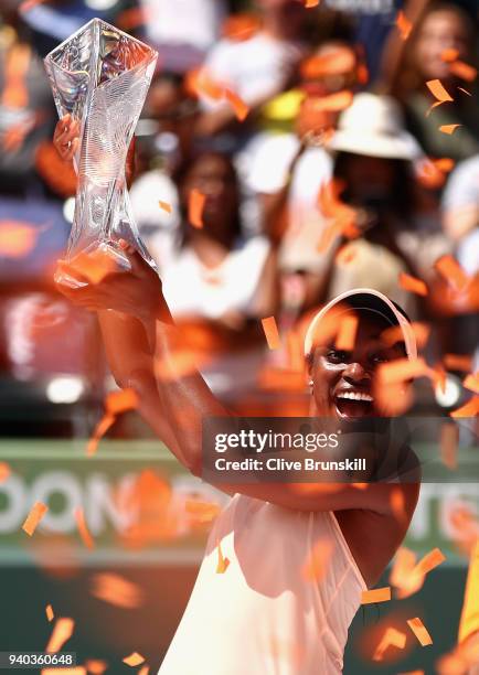 Sloane Stephens of the United States holds aloft the Miami Open trophy after her straight sets victory against Jelena Ostapenko of Latvia in the...