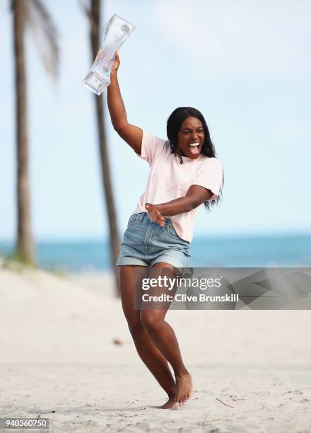 Sloane Stephens of the United States on Crandon Park Beach with the Miami Open trophy after her straight sets victory against Jelena Ostapenko of...