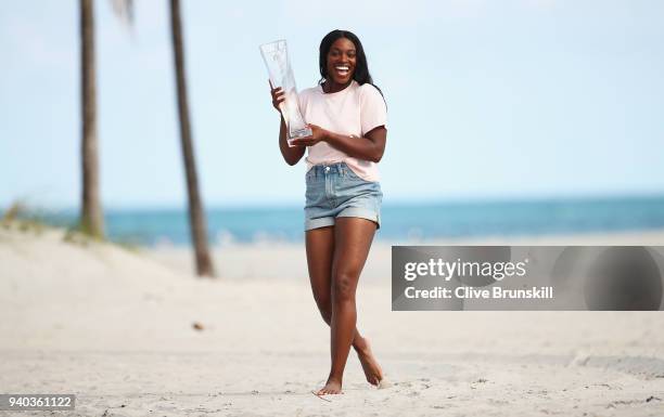 Sloane Stephens of the United States on Crandon Park Beach with the Miami Open trophy after her straight sets victory against Jelena Ostapenko of...