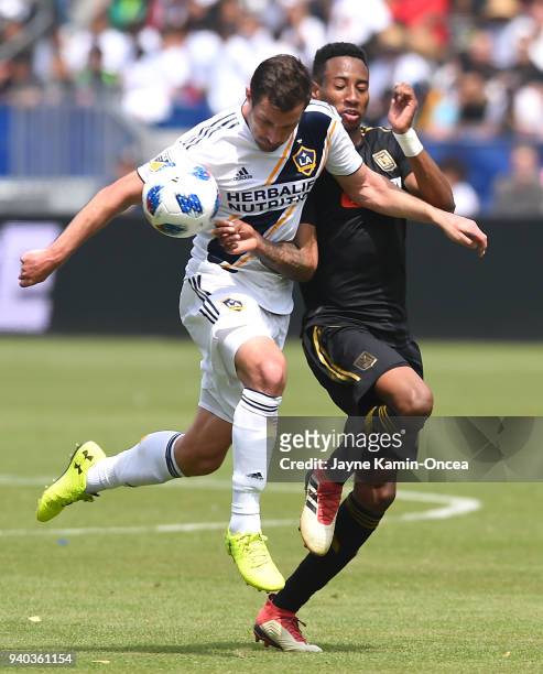 Chris Pontius of Los Angeles Galaxy and Mark-Anthony Kaye of the Los Angeles FC battle for the ball in the second half of the game at StubHub Center...