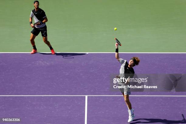 Andrey Rublev of Russia returns a shot against Bob Bryan and Mike Bryan of the United States while playing with Karen Khachanov of Russia during the...