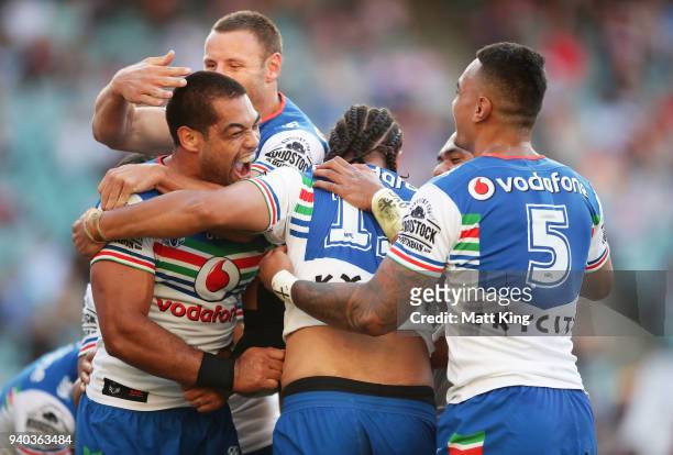 Adam Blair of the Warriors celebrate the try to Leivaha Pulu of the Warriors with team mates during the round four NRL match between the Sydney...
