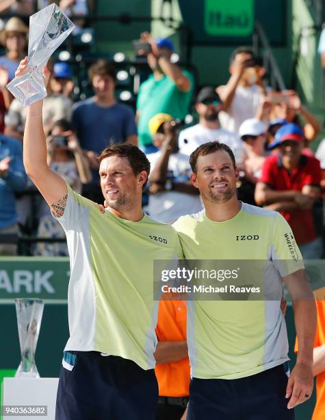 Bob and Mike Bryan pose for a photo with the Miami Open trophy after defeating Karen Khachanov and Andrey Rublev of Russia during the men's doubles...