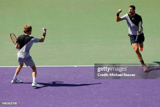 Karen Khachanov and Andrey Rublev of Russia celebrate after a point against Bob Bryan and Mike Bryan of the United States during the men's doubles...