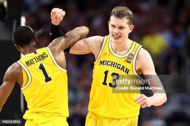 Moritz Wagner of the Michigan Wolverines reacts with Charles Matthews in the second half against the Loyola Ramblers during the 2018 NCAA Men's Final...
